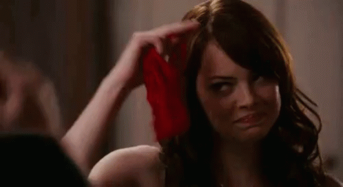 Emma Stone saluting with red panties in hand