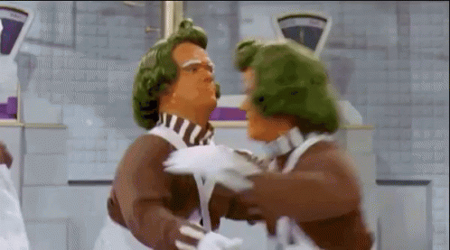Six Oompa Loompas from Willy Wonka and the Chocolate Factory film performing a dance routine